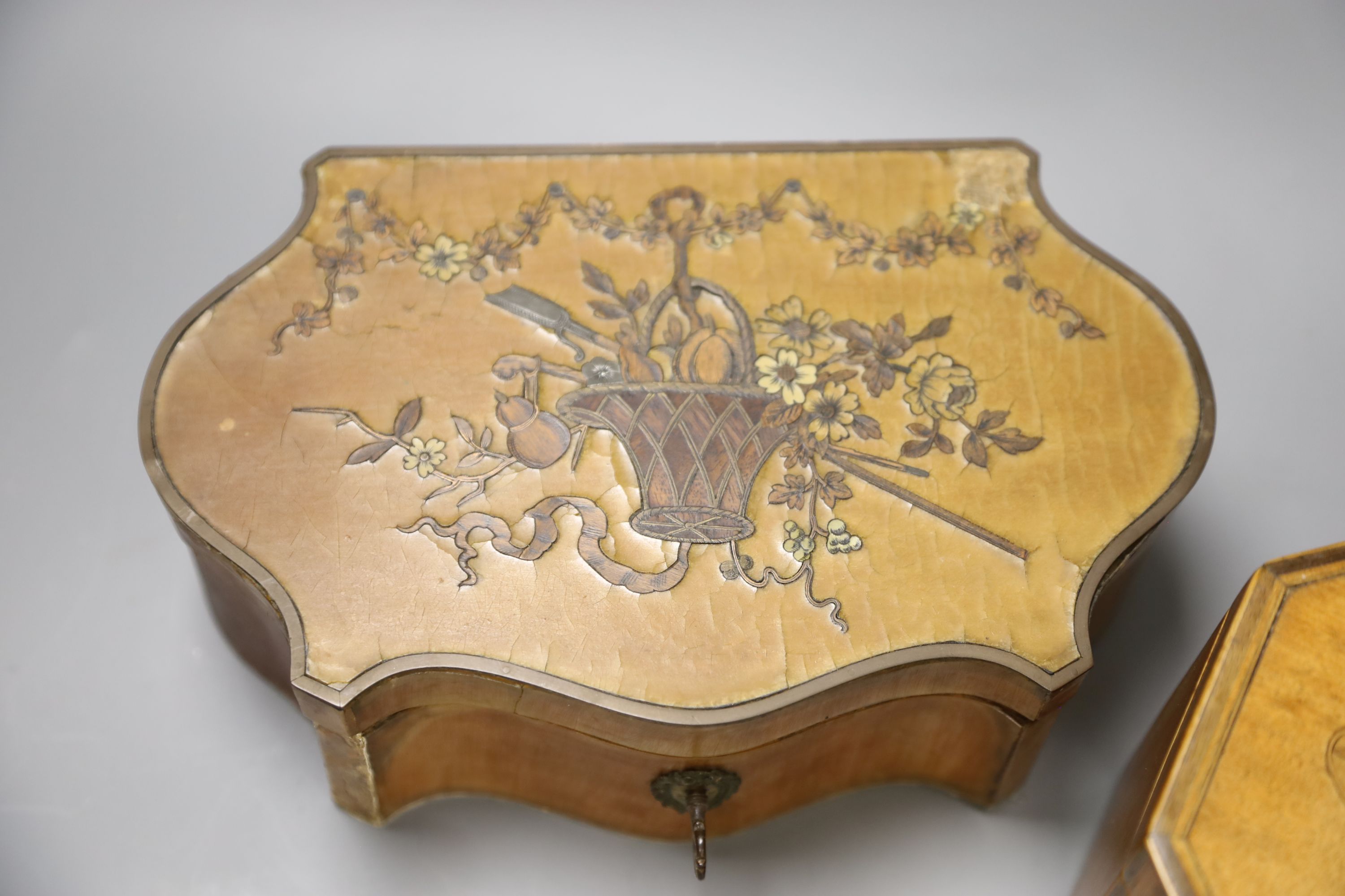 A marquetry serpentine work box, length 23.5cm, and an octagonal tea caddy